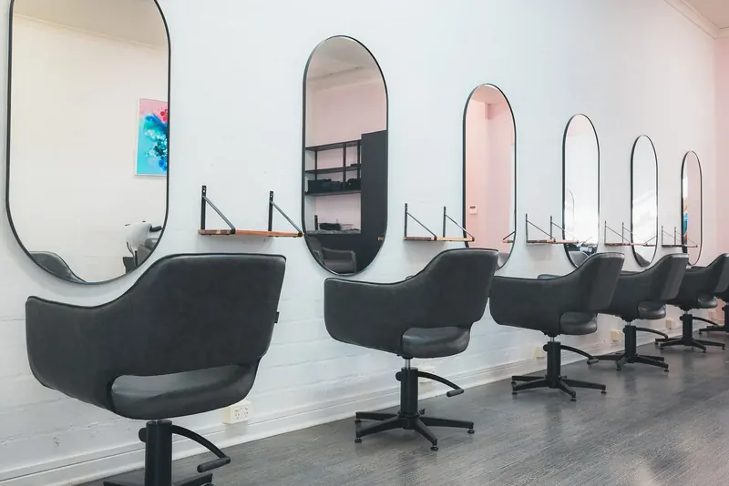 Arched mirrors and styling chairs inside the salon